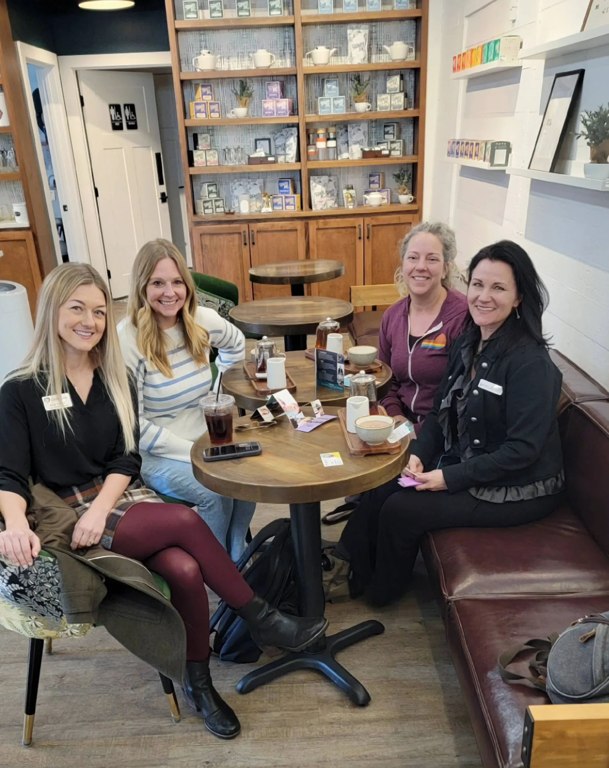 Group of 4 women networking at a coffee shop